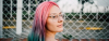 Young woman with pink blue green hair and glasses