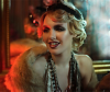 Woman dressed as a flapper girl in dimly lit room with orange hue