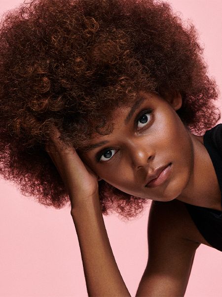 Woman with afro and pink background