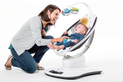 Mother engaging with her baby in a rocker