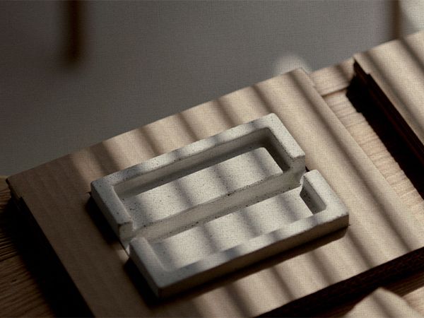 white Shampoon Bar soap dish lays in its eco-friendly packaging on top of a wooden table