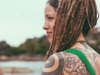 Brunette woman with dreadlocks and lots of tattoos