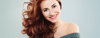 Nice young woman with long red brown hair smiling