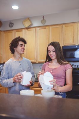 Couple eating Chinese food in the kitchen