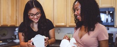 Couple eating Chinese food in the kitchen