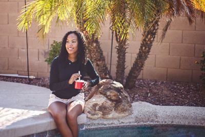 Woman eating by the pool