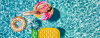 Woman enjoys being in a pool sunbathing on a lollipop shaped floating rubber