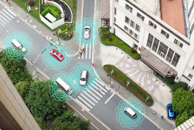 Illustration of autonomous self-driving vehicles in a city showing sensors