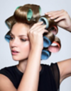 Woman with colorful velcro rollers in hair