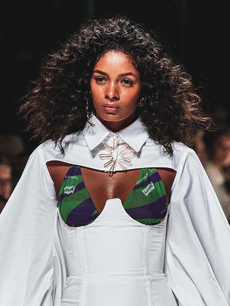 Model with naturally curly hair on the catwalk at Mercedes-Benz Fashion Week