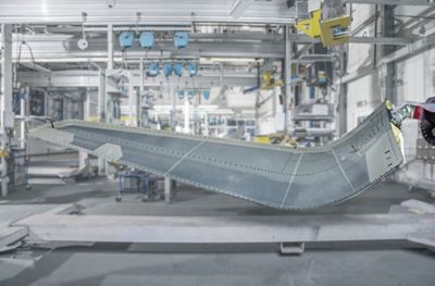 Photo of airplane wing during manufacturing represents structural adhesive solutions for aircraft manufacturing and repair