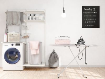 ironed clothes next to a washing machine and an iron