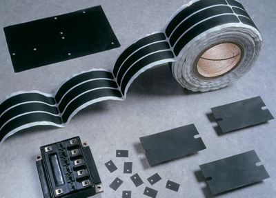 Photo of black bergquist q-pad 3 fiberglass-reinforced thermal interface products including die-cut parts, roll and sheet this product line is used as a replacement for thermal grease and eliminates problems associated with thermal grease such as contamination of electronic assemblies and reflow solder baths