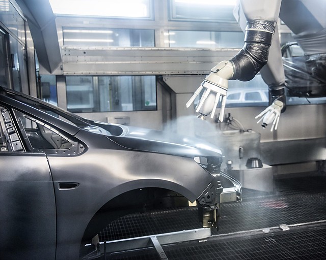Car body in a production line sprayed with paint by a robot