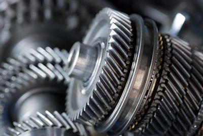 Closeup of forged metal gears inside a vehicle gearbox