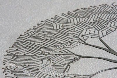 Photo of loctite 1006 a silver electrically conductive ink creating a tree pattern on a circuit board