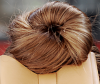 Woman with messy bun in blondette color