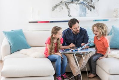 father and child reading in book