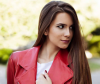 Woman with ash brown hair and red jacket