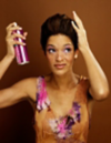 Brunette woman using hairspray