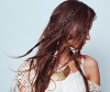 Model with long middle-parted hair and boho, wavy hairstyle