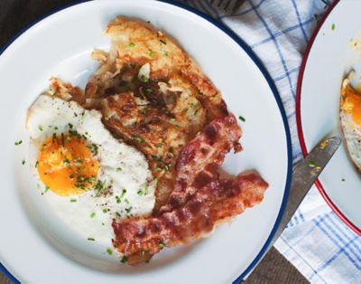 Hash browns with fried eggs and bacon