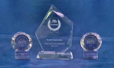 Photo of three innovation award plaques given to Henkel at the IPC APEX Expo 2019 for Bergquist gap pad TGP 7000ULM and Loctite Eccobond UF1173 blue background