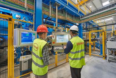 Two employees working with digital interface inside the montornes del valles spain smart aerospace adhesives manufacturing facility