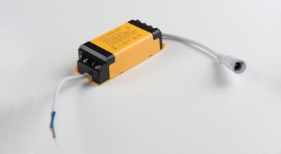 Photo of yelow and black LED panel driver used to rectify higher voltage, alternating current to low voltage, direct current shutterstock ID 1030507273