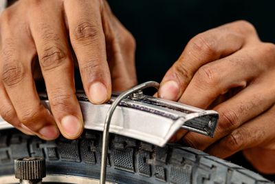 A torn-off holder is pressed onto a bicycle rim. 