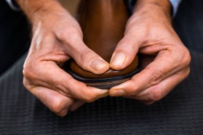 Male hands pressing tip of a shoe