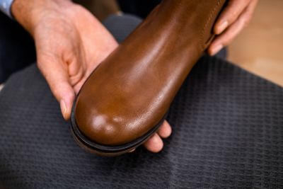 Repaired shoe in male hands