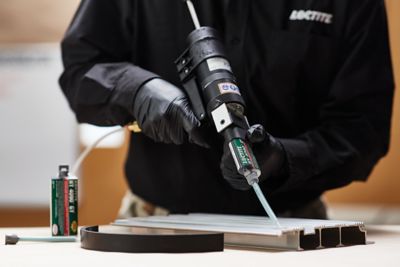 Person using LOCTITE HY 4090 on metal