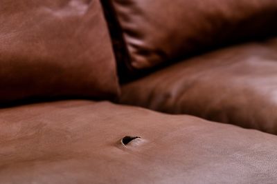 A hole in a leather couch.