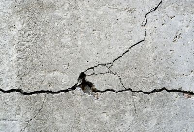 Thin cracks in a concrete wall.