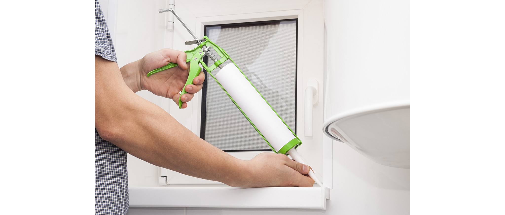 caulking gun and window