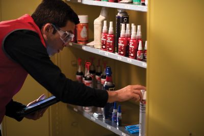 man looking at loctite products on a shelf