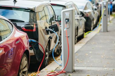 electric vehicles parked in a row, charging