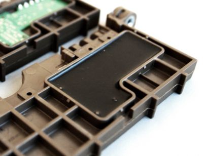 Photo showing before and after applying potting material into mold over printed circuit board assembly for insulating and protecting sensitive electronic components