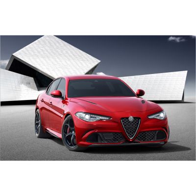 Red Alfa Romeo Giulia sedan with white geometric building in background