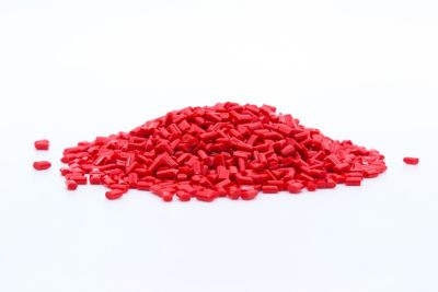 Photo of red plastic polymer granules on a white background shutterstock ID 1061799857