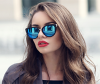 Woman with dyed brunette hair and sunglasses