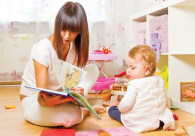 Woman reading book to child