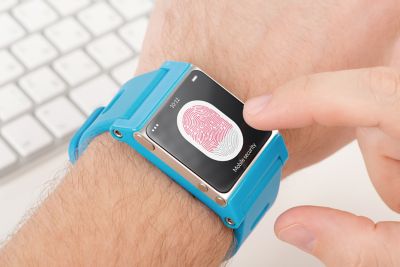 Photo of man scanning fingerprint on touchscreen of a blue smart watch for identification and  security shutterstock ID 193504472
