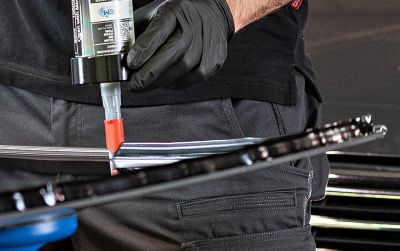 Stage image on windscreen adhesive being applied