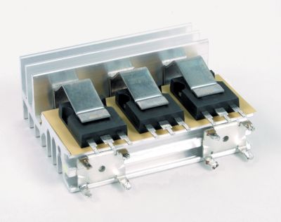 Photo of yellow bergquist sil pad thermal interface material used in a power supply application for electrical insulation and thermal management