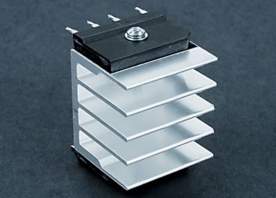 Photo of high power four lead transistor on a metal heatsink with bergquist q pad ii thermal interface material a direct replacement for silicon grease