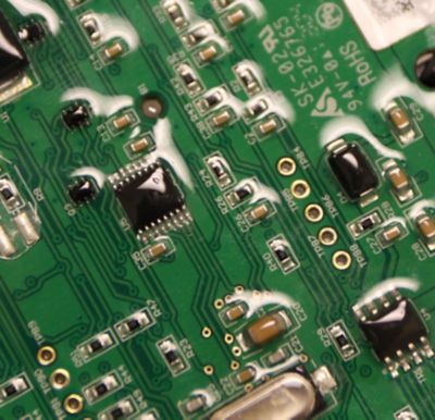 Closeup photo of printed circuit board with conformal coating for waterproofing
