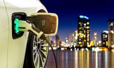 Electric vehicle charges in the city at night