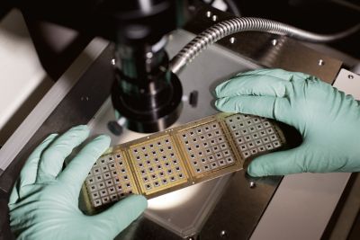 Scientist holds strip of die attach paste